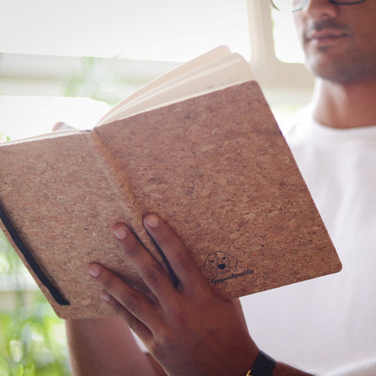 man holding A5 cork diary by flippysustainables | premium looking cork texture | 80 GSM | 160 pages | Ruled