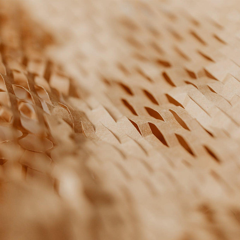 Close-up view of brown honeycomb kraft paper showcasing its intricate and textured pattern, perfect for eco-friendly gift wrapping and packaging solutions.